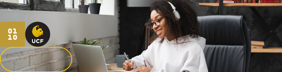 Person at desk with laptop, UCF logo visible, symbolizing Central Florida’s cybersecurity focus